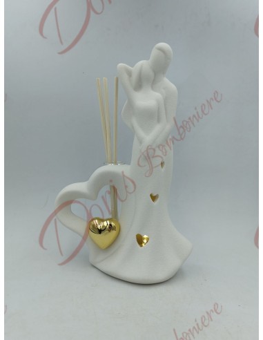 Wedding favors hug couple in love in white porcelain with scented gold heart and led light