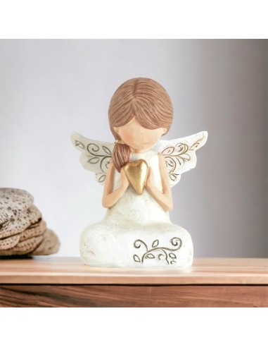 First communion favor girl angel sitting with gold heart in her hands in handcrafted resin