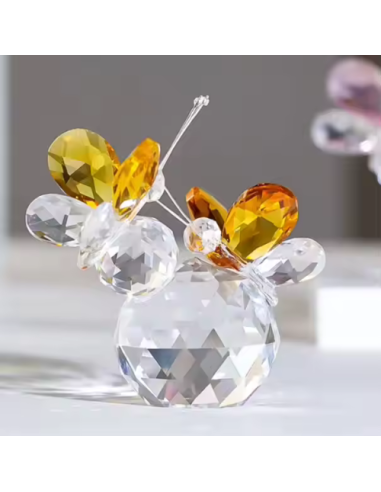 Crystal favors pair of amber yellow butterflies resting on a sphere