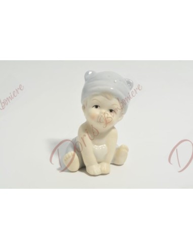 Bebè femmina in porcellana con dettagli colore azzurro, h 8 x ∅ 8.5 cm Bebè femmina in porcellana con dettagli colore azzurro, h 8 x ∅ 8.5 cm