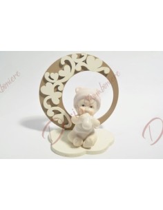 Porcelain baby girl with pink details on wooden base 10 x 10.5 cm